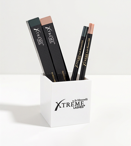 A grid layout showcases numerous Xtreme Lashes GlideLiner Sharpeners as seen from an top-down view. The image emphasizes the quantity of these identical black, square-shaped sharpeners included in the restock kit.