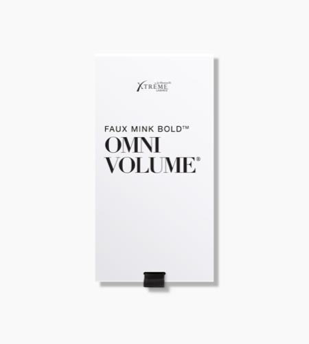 Close-up of the Xtreme Lashes Omni Volume lash extension product packaging, featuring the product name in black text on a white background.
